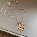 Golden sun pendant necklace with spiral center on gold snake chain and beads - Necklace - Gold
