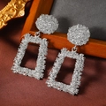 Detail of silver geometric textured earrings with round and rectangular metal frames - White K (WEH3965)