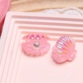 Macro shot of 3D resin pink pearlescent shell charms with iridescent finish on display - Pink