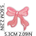Pink embroidered bow patch with size dimensions showing 5.6cm height and 5.3cm width - US 7
