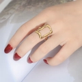 Irregular hollow rectangle gold ring on a hand with red nails over a book - Adjustable Open / Irregular Hollow Style (Gold 2)