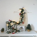 Close-up of artificial pine garland with snow effect, red berries, cones and LED lights - Double White Pine Needle + Red Berry + Pine Cone Garland