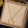 Detailed close-up of golden heart and wing pendant necklace on champagne jewelry box - Heart Wings (XL1494-23)