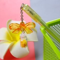 Cute school stationery pendant with orange acrylic bow and yellow mini bottle charm - Butterfly Drift Bottle - Yellow