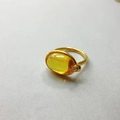 Macro shot of 18K gold plated ring featuring oval yellow gemstone and sparkling zircon - US 6 / Yellow