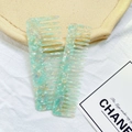Close-up of wide-tooth hair combs featuring rainbow iridescent green marble acetate finish - Two-Piece Set / 2-Piece Set - Green