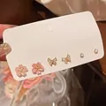 Close-up of S925 silver set featuring cherry blossom, butterfly and zircon stud earrings - Cherry Blossom Rhinestone Butterfly Set