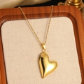 Elegant gold heart pendant necklace on a premium linen display for a beach vacation style - Gold Fashion Large 3D Heart Pendant Necklace