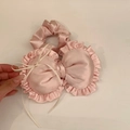 Nahaufnahme eines süßen rosa gerüschten herzförmigen Haargummis mit Satin-Finish-Detail - Rosa Schleife