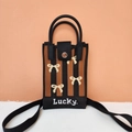 Detailed texture of knitted crossbody bag featuring pixelated bow pattern and Lucky. text - Striped Bow (Coffee)