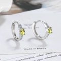 Macro shot of silver clasp earrings with oval yellow zircon and white pave micro-stones - Olive Green Zirconia