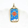 Detailed macro of golden THE SUN tarot card pendant with blue enamel and sun design - Blue Sun Pendant / Pendant Only