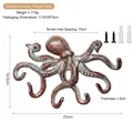 Antique rust red cast iron octopus wall hook with four tentacles and mounting screws - Rust Red Bronze
