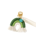 Detail showing handmade woven rainbow keychain with green cotton fringe and blue floral charm - Green