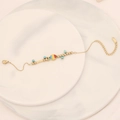 Detail of a gold stainless steel bracelet with blue beads and a colorful fish pendant - Multi-color Patchwork Fish Style(7#)