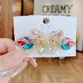 Barrette à cheveux papillon dorée avec strass en cristal multicolores sur carte - Coloré