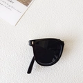 Foldable black kids sunglasses with square frames and silver rivets on sandy background - Black