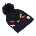 Detail of navy knit beanie showing colorful dinosaur embroidery and a fluffy pom-pom - 2-6 Years Old / Deep Navy Blue
