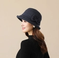 Detail showing the side bow and houndstooth pattern on a blue wool bucket hat - Navy Blue