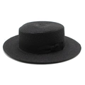 Detail of the woven texture and black ribbon bow on a black flat-top boater straw hat - Black