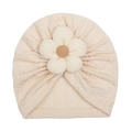 Macro detail of beige knitted baby hat featuring a 3D floral decoration on soft fabric - Beige