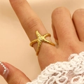 Detailed close-up of a gold starfish ring with relief texture on a model's finger - 18k Gold Small Starfish Style (WG-1135)