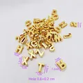 Macro shot of gold letter beads showing dimensions of 1.2x1cm and 0.8x0.2cm hole size - Gold Mixed Color Perforated Letters Plated