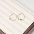 Elegant gold hoop earrings featuring three geometric faceted metal beads in a jewelry box - Gold Lattice Ring