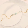 Detailed shot of a gold chain bracelet with blue enamel oval charms on a marble tray - Blue Oval Ring Style(10#)