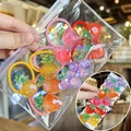 Close-up of colorful glittery resin fruit hair ties including strawberry and pineapple shapes - Glitter Fruit Shape Style (TS-2)