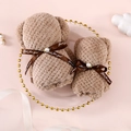 Set of two brown bear-shaped towels with decorative ribbons on a pink background - Brown Pearl Bear