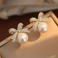 Elegant gold bow earrings with pavé crystals and a large white round hanging pearl - Full Rhinestone Bow Large Artificial Pearl Style