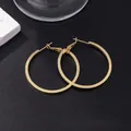 Polished large golden hoop earrings with smooth metal finish on a minimalist black background - E-076---gold 30mm