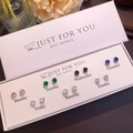 Close-up of 7 pairs of colorful butterfly stud earrings in a white weekly gift box - Set of 7 Pairs Colored Zirconia Heart Star Style (NS-11031-6)