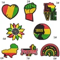 Close-up of 8 colorful Pan-African embroidered patches with heart and power fist motifs - 8-Piece Patch Set