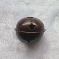 Brown 5cm metal Christmas bell with star cutout on a soft white plush background - Star Painted Coffee