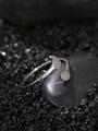 Macro shot of silver luminous ring with crescent and round geometric metal plates - Circular Style (NR294)