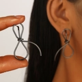 Matte black oversized bow stud earrings featuring a minimalist hollow metal wire design - Abstract Bow Wire Wrapped Earrings / Gun Black (Gun Black Bow DZ-435-25)