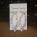 Golden bow stud earrings with sparkling rhinestones and white U-shaped pearl drops - Bowknot Pearl Drop Earrings
