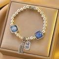 Silver bead bracelet with blue cat's eye stones and Lucky Talisman charms - Silver Fortune Abacus Bracelet (X758)