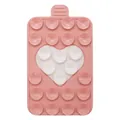 Detail view of pink silicone suction cup phone holder with a white heart-shaped design - Pink + White