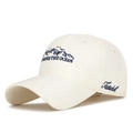 Creamy white baseball cap featuring blue mountain embroidery and Ocean text design - Adjustable / Light Beige