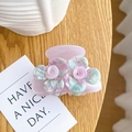 Pink camellia acetate hair claw clip with mint green accents on a wooden table - 6cm / Light Purple