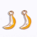 Close-up of yellow enamel banana charms with gold metal frames for DIY jewelry making - Little Banana
