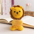 Handmade crochet positive lion doll in yellow and brown holding an English card - Sitting Lion Style 2