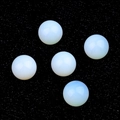 Five round non-porous white synthetic opal beads displayed on a textured black background - Synthetic Opal