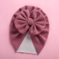 Detailed knit texture of a mauve baby turban hat featuring a large decorative bow - 18*21cm / Fuschia