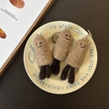 Handmade brown wool felt peanut keychains in a decorative ceramic plate - Peanut Trio
