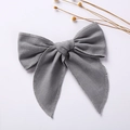 Detailed close-up of a grey cotton linen bow hair clip with fine stitching edges - Gray
