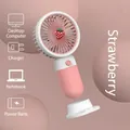Pink strawberry handheld mini fan showing USB charging options and detachable base - Strawberry Pink